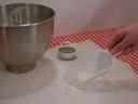 Sprinkling flour over pastry cloth